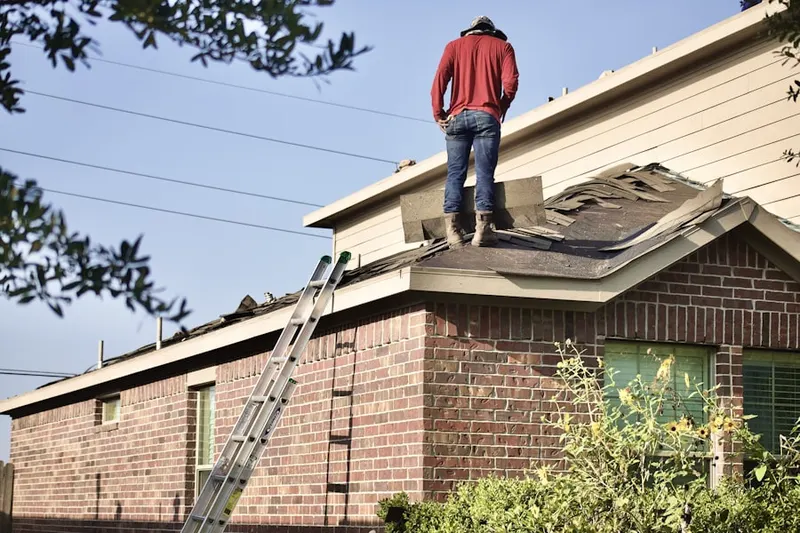 Professional roofer working on a residential roof in Lawndale